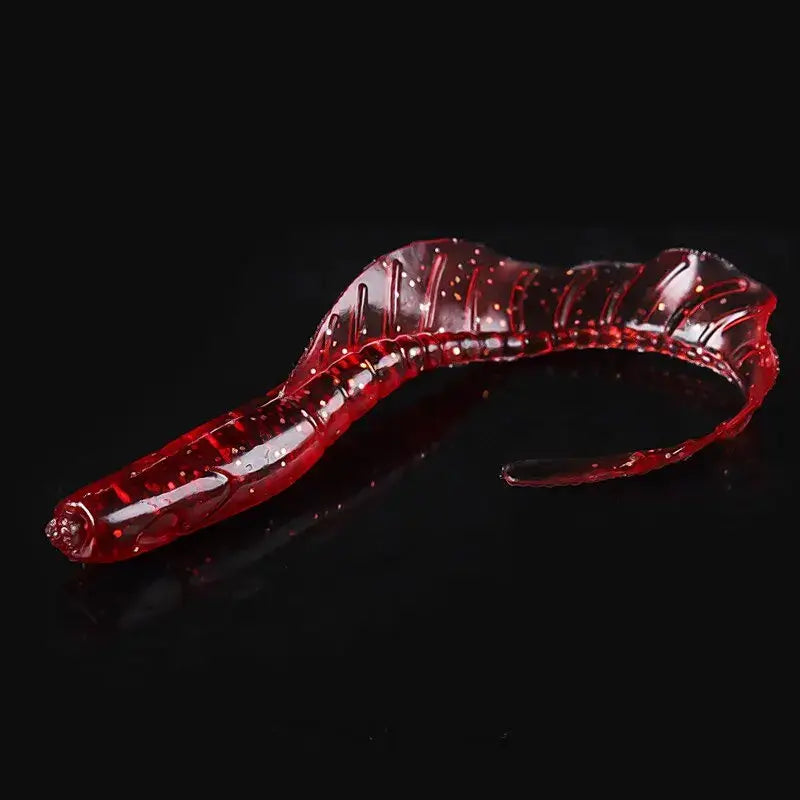 Red, translucent, segmented, worm-shaped fishing lure.