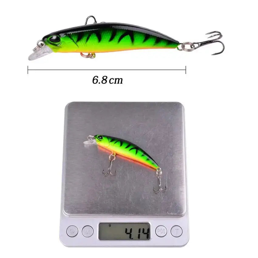 Green and black fishing lure with hooks.