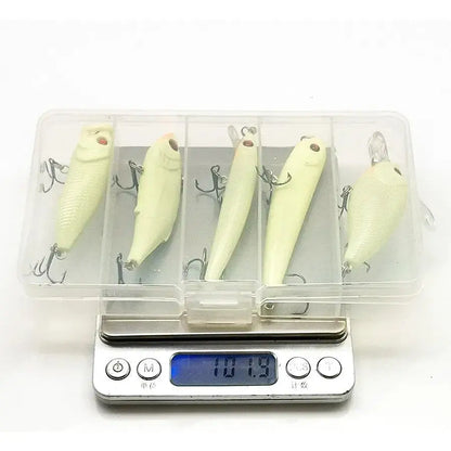 Fishing lures in a plastic case on a digital scale.