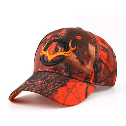 Orange camouflage baseball cap with black embroidered deer antlers. High-visibility design for hunting, fishing, and outdoor activities.